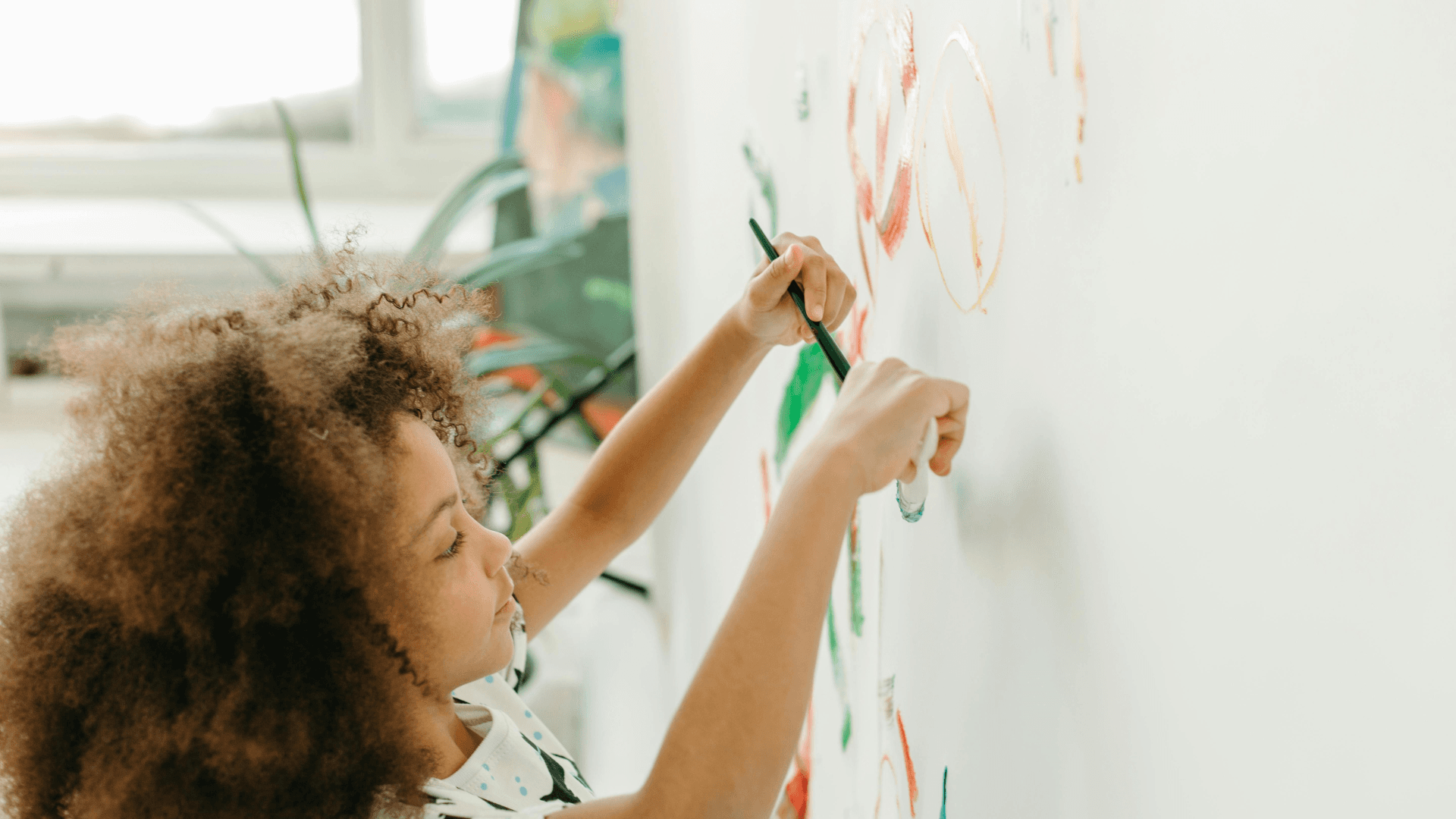 Child drawing on whiteboard