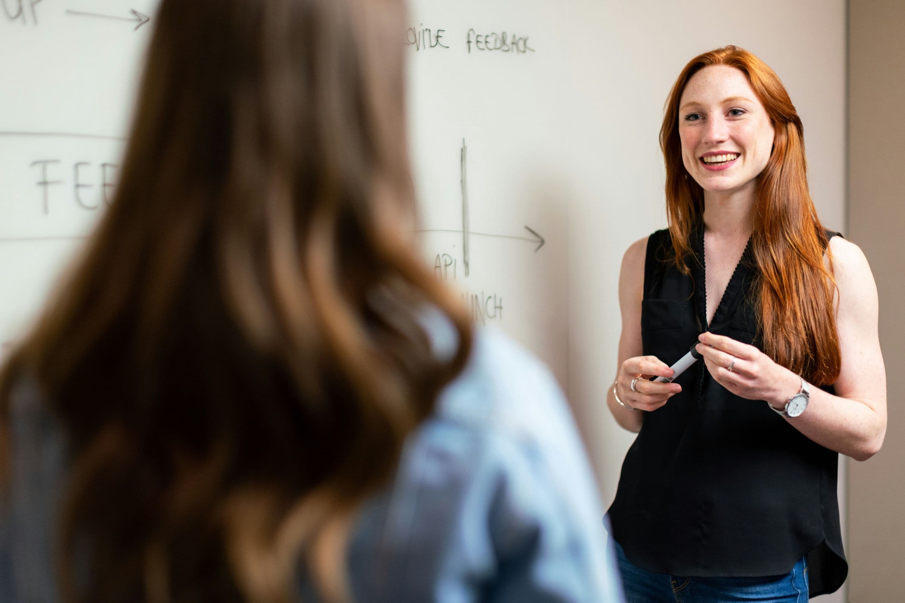 woman working with colleague smiling